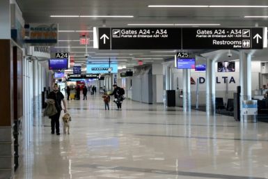 Travelers walk through Hartsfield-Jackson Atlanta International Airport in April 2020