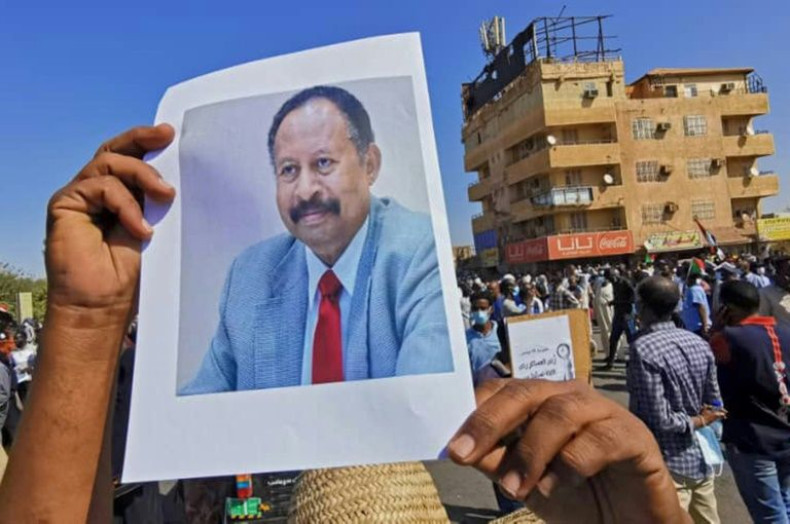 A Sudanese anti-coup protester carries a portrait of Prime Minister Abdalla Hamdok on November 13
