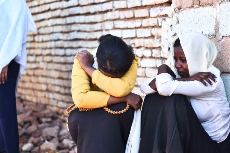 Friends of a Sudanese protester react during her funeral in Khartoum on November 20