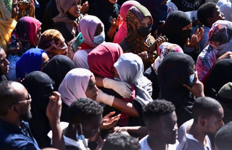 Women comfort one another during the funeral procession for a Sudanese protester in the capital Khartoum on November 20