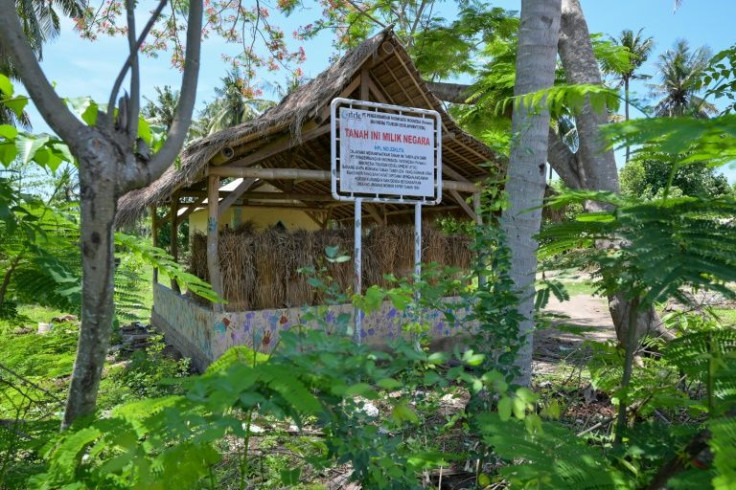 A sign on an abandoned hut reads: "This land belongs to the state"