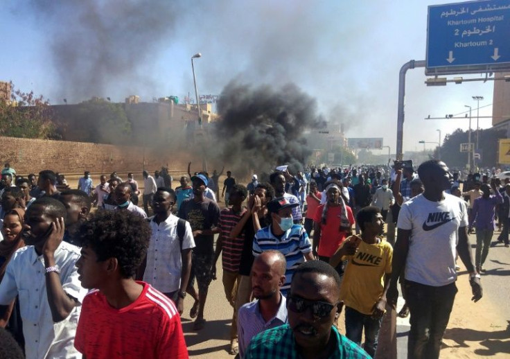 Sudanese protesters burn tyres as they rally on a street in the capital Khartoum, on November 21, 2021