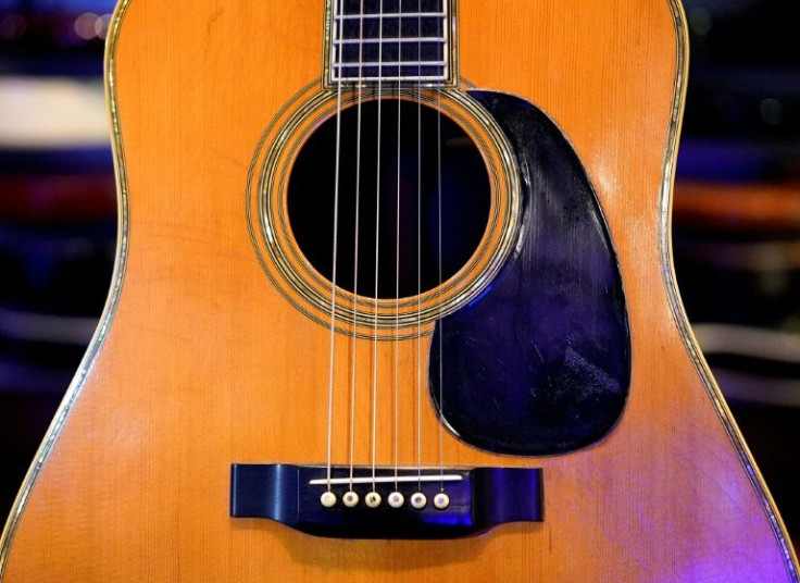 An acoustic guitar played by rock legend Eric Clapton sold at auction in New York for $625,000