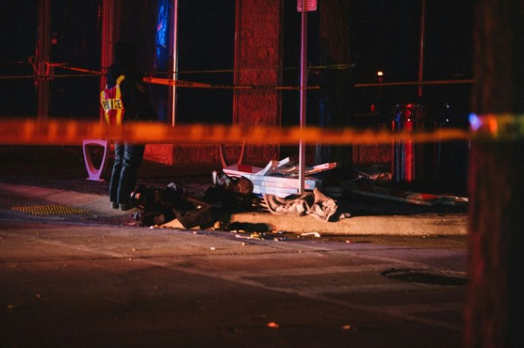 Debris litters a street in Waukesha, Wisconsin, where a car plowed through a holiday parade, leaving multiple people dead