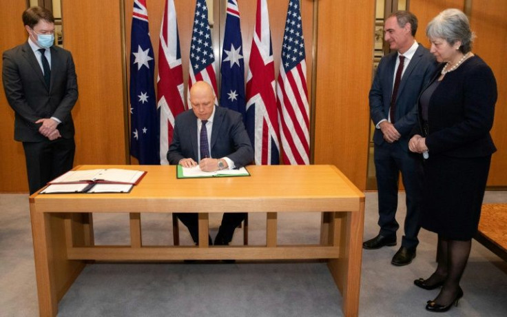 Australian Defence Minister Peter Dutton signed the agreement along with US Charge d'Affaires Michael Goldman (2nd R) and British High Commissioner Victoria Treadell (R)