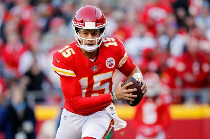 Kansas City Chiefs quarterback Patrick Mahomes scrambles out of the pocket against the Dallas Cowboys in the second quarter of their NFL game at Arrowhead Stadium
