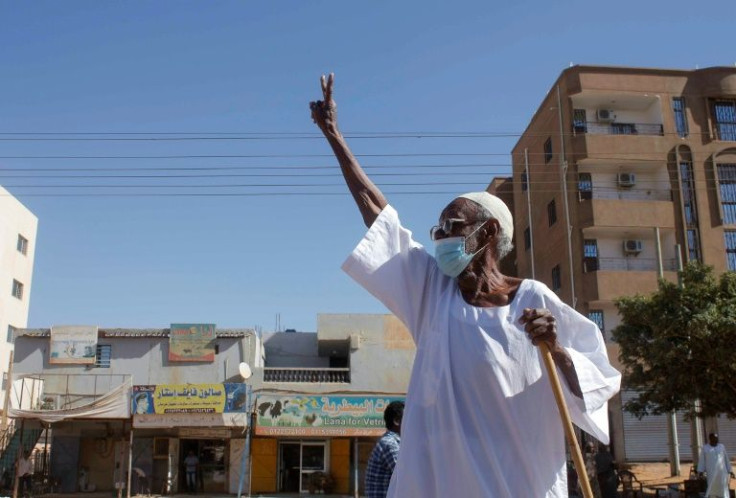 An elderly Sudanese man flashes the victory sign as protesters rally to call for a return to civilian rule in the capital Khartoum on November 21