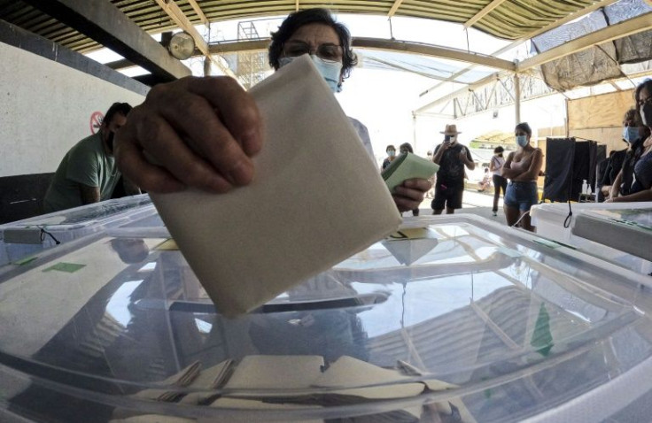 A woman casts her vote in Chile's presidential elections at a polling station in Santiago on November 21, 2021