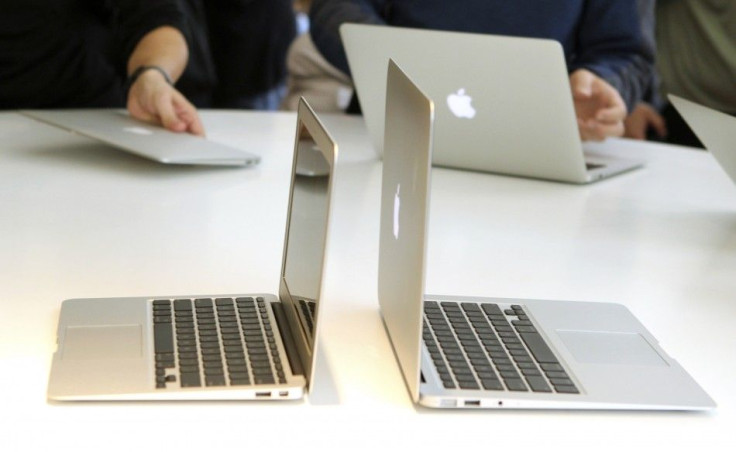 Media and guests check out the latest thinner MacBook Air models after attending a news conference at Apple Inc. headquarters in Cupertino