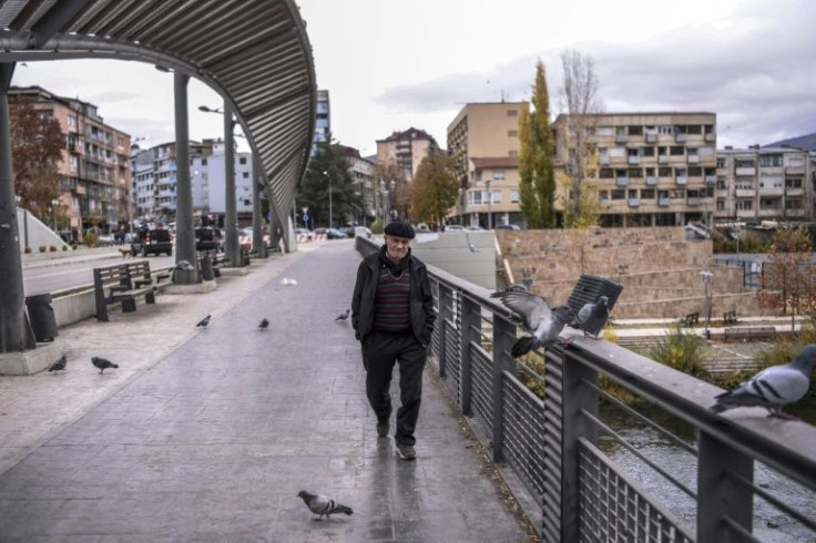A Kosovo Albanian man crosses the Ibar bridge in Mitrovica which divides his community and the Serbian minority