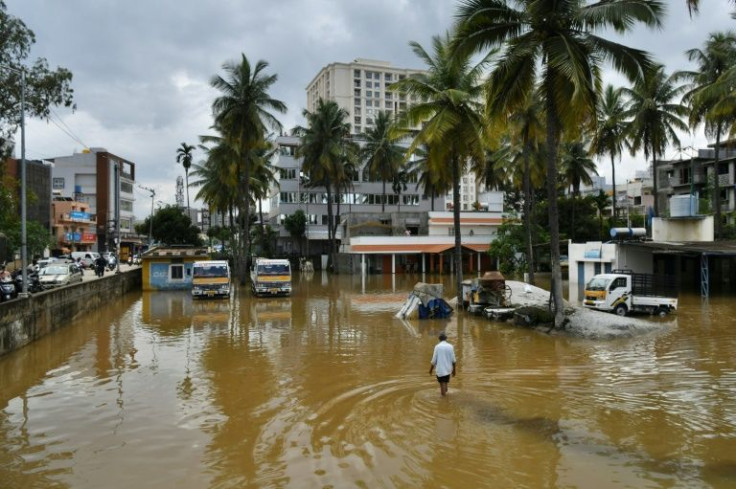 A man wades through a waterlogged area in Bangalore