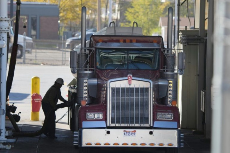 A trucker loads his truck with fuel in Salt Lake City, Utah, as residents and businesses in the United States and other nations grapple with high oil and gas prices