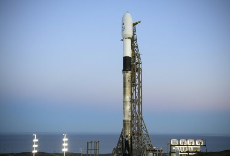 In this image released by NASA, the SpaceX Falcon 9 rocket with the Double Asteroid Redirection Test, or DART, spacecraft onboard, is seen during sunrise, November 23, 2021