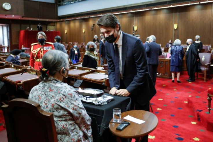 Canada's Prime Minister Justin Trudeau talks with Inuit elder Sally Webster in the Senate chamber in Ottawa ahead of the throne speech outlining his government's legislative priorities, which includes hastening reconciliation with indigenous peoples