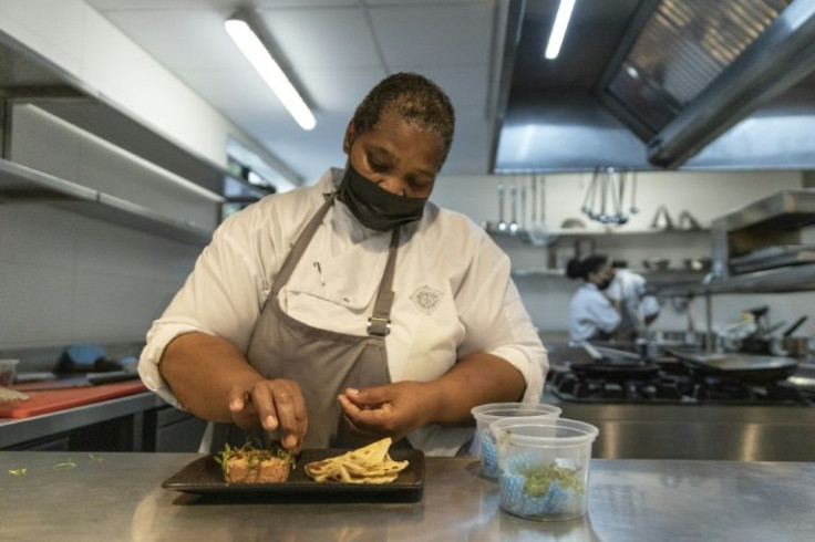 Nelson Mandela's personal chef Xoliswa Ndoyiya prepares a dish at the hotel restaurant in his former home