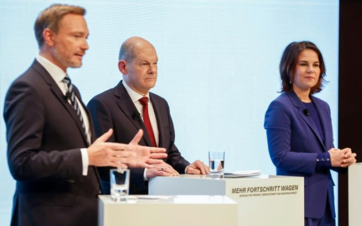 Scholz (centre), who Der Spiegel magazine once described as "the embodiment of boredom in politics", will head a 'traffic light' coalition with the Free Democrats of Christian Lindner (L) and the Greens' co-leader Annalena Baerbock (r)