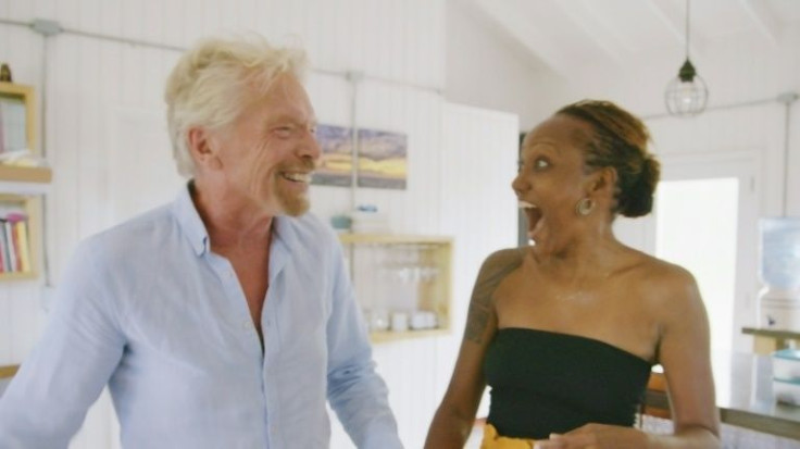 Virgin Galactic founder Richard Branson (L) surprises space travel sweepstakes winner Keisha Schahaff at her home on Antigua on November 6, 2021