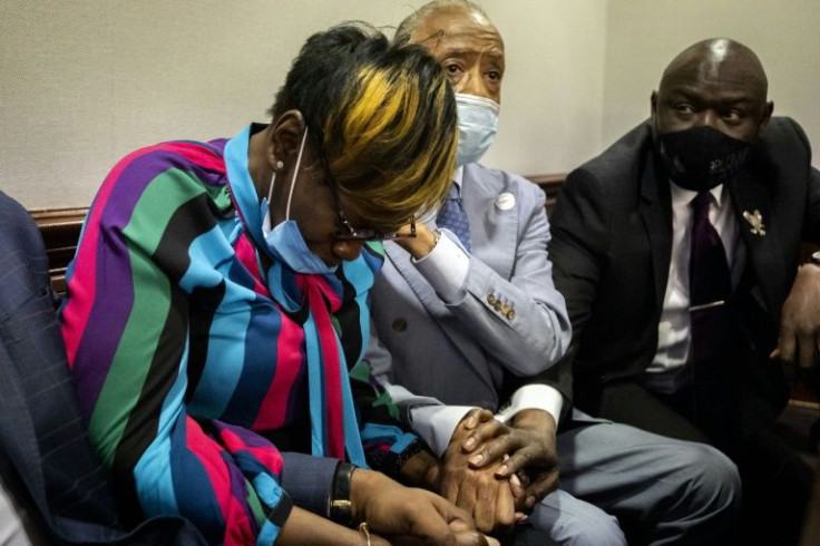 Ahmaud Arbery's mother, Wanda Cooper-Jones, left, is comforted by the Reverend Al Sharpton after the guilty verdicts were announced in the trial of the murderers of her son