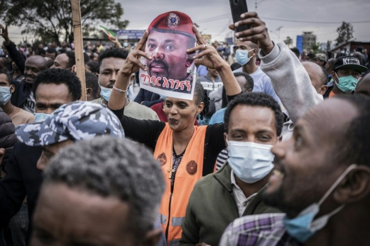 A woman holds a poster of Ethiopian Prime Ministe Abiy Ahmed during a protest
