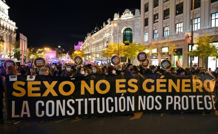 People hold a banner reading "Sex is not gender. The Constitution protects us" during a demonstration in Madrid