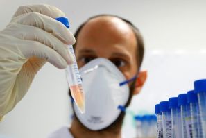A lab technician holds a tube containing a swab sample taken for Covid-19 serological test at the Leumit Health Services laboratory in the Israeli city of Or Yehuda in this file picture taken on July 16, 2020