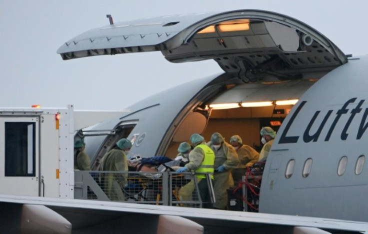 Medics transfer a coronavirus patient onto a medical transport plane at Memmingen Airport, Bavaria