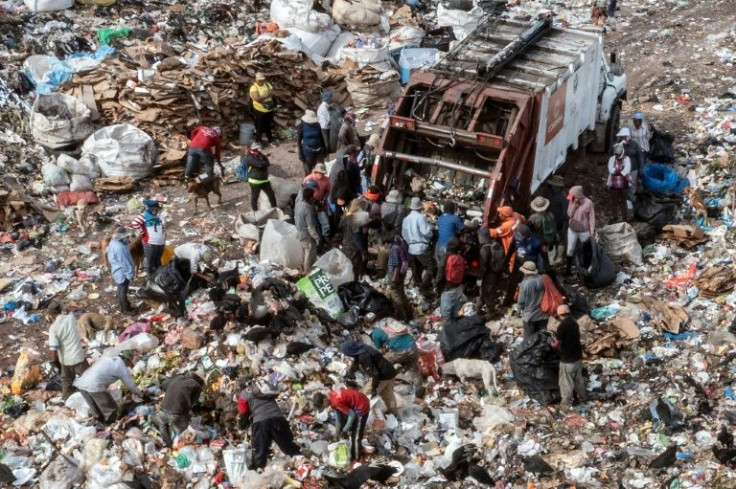 An aerial shot of people looking through rubbish for pieces of plastic or metal to sell at a municipal dump on the outskirts of Tegucigalpa