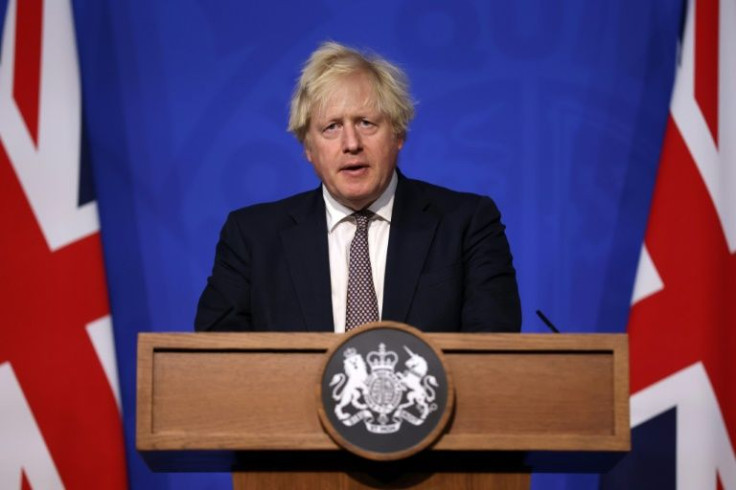 Prime Minister Boris Johnson announces tougher rules in a bid to curb the spread of a new variant of Covid-19