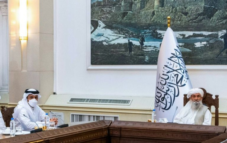 Afghan Prime Minister Mullah Mohammad Hassan Akhund (R, pictured September 2021 in a handout photo from Qatar's Ministry of Foreign Affairs) pleaded international organizations to continue sending aid to his country