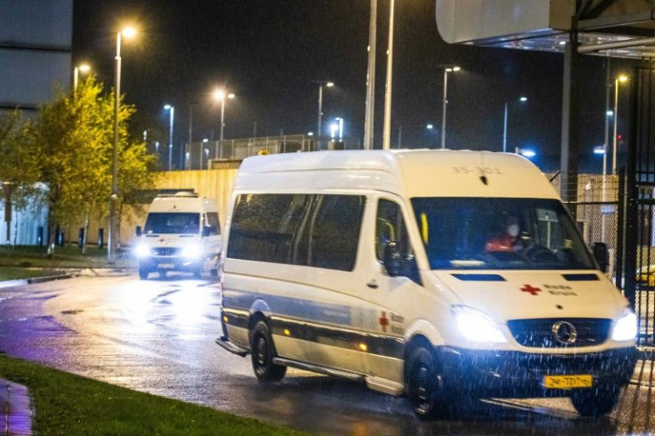 A Red Cross van transporting arrivals from South Africa to a hotel where they will be quarantined after testing positive for Covid-19