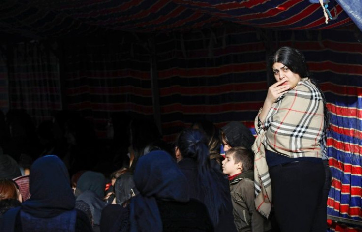 Women attend a condolence ceremony for Iraqi Kurdish migrant Maryam Nuri Hama Amin, also known as Baran, in the town of Soran in Iraq's autonomous Kurdish region