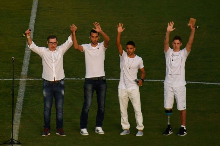 Survivors of the crash that killed most of the Chapecoense football team: (L-R) Rafael Henzel, Helio Hermito Zampier Neto, Alan Ruschel and Jakson Follmann, wave in the Arena Conda stadium ahead of the Recopa Sudamericana 2017 football match between Colom