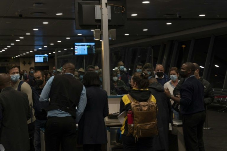 Travellers throng Johannesburg international airport, desperate to catch last flights to countries that have imposed sudden travel bans