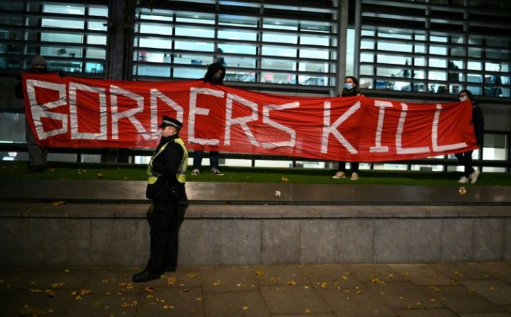 Protestors hold a banner reading "Borders Kill" as they  demonstrate against the British government's policy on immigration outside of the Home Office in central London on November 25, 2021, following the death of 27 migrants crossing the Channel