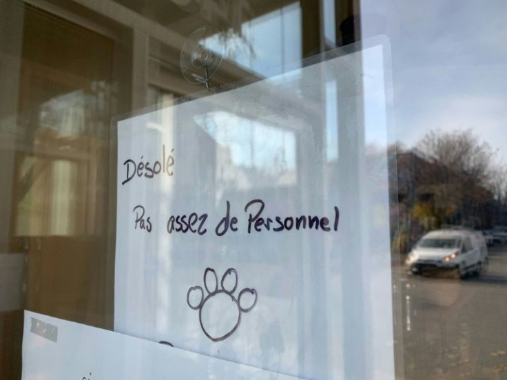 A sign that says "Sorry, not enough employees" hangs on the window of a restaurant called La Panthere Verte in Montreal, Quebec November 11, 2021
