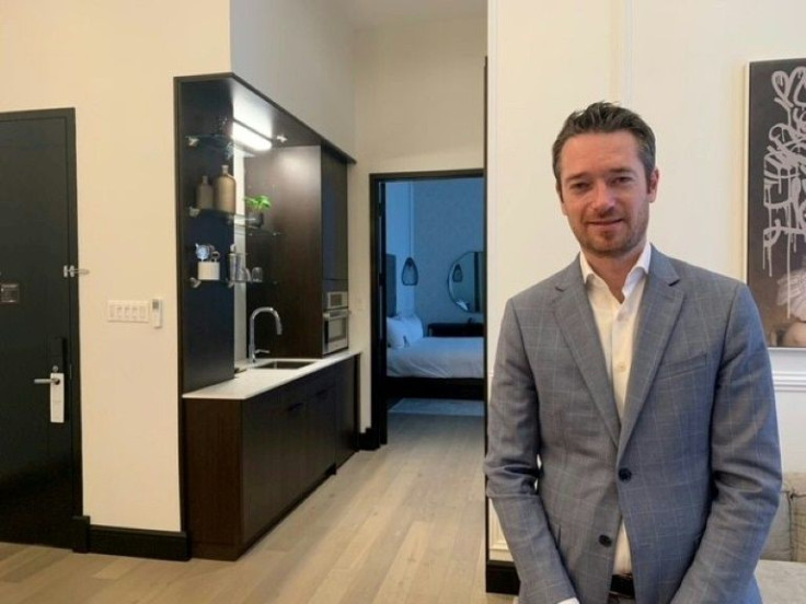 Benoit Pretet who works as a manager in Hotel Place dâArmes, in old Montreal, Quebec, poses for a picture on November 11, 2021