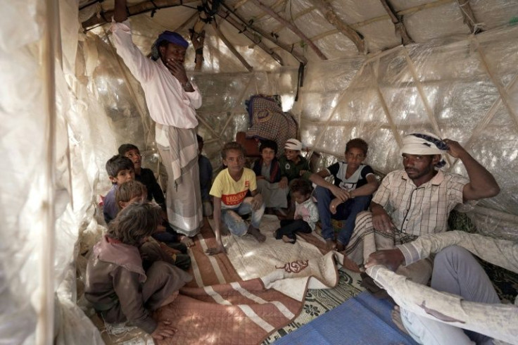 Yehya Hayba (R) and his children, who fled fighting between Huthi rebels and the Saudi-backed government forces, stay at the Al-Sumya camp for internally displaced persons east of Marib city on November 24, 2021