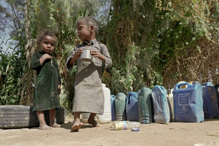 Children drink water at the Al-Sumya camp for internally displaced persons (IDP) east of Marib city, the last remaining government stronghold in northern Yemen, on November 24, 2021