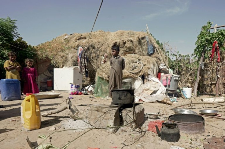Children stand outside a tent at the Al-Sumya camp for internally displaced persons (IDP) east of Marib city, the last remaining government stronghold in northern Yemen, on November 24, 2021