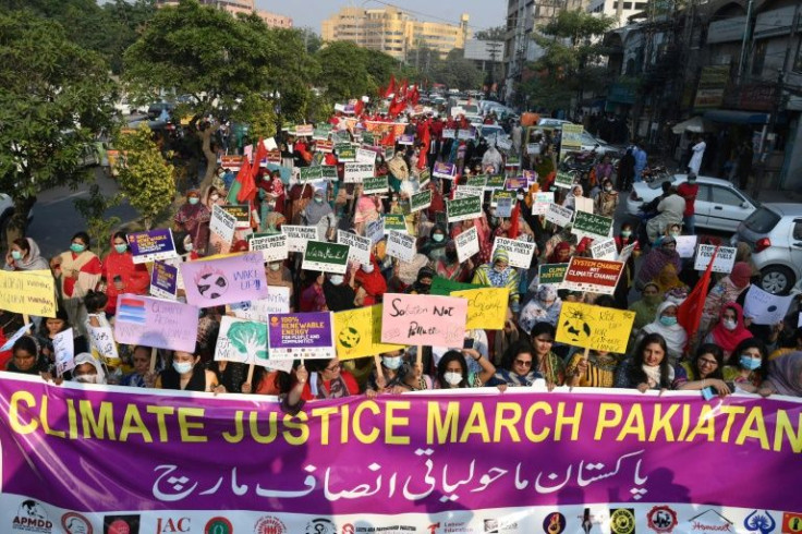 Human rights activists hold placards in Lahore on November 8 during a protest in connection with the COP26 UN Climate Change Conference