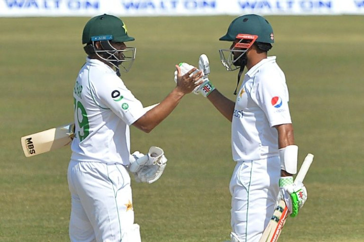 Pakistan's captain Babar Azam (left) celebrates with teammate Azhar Ali after a win over Bangladesh in the first Test