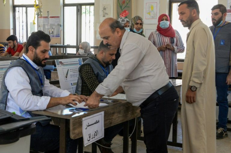 An Iraqi man registers to vote at a polling station in the northern city of Mosul, on October 10, 2021, during the country's parliamentary elections