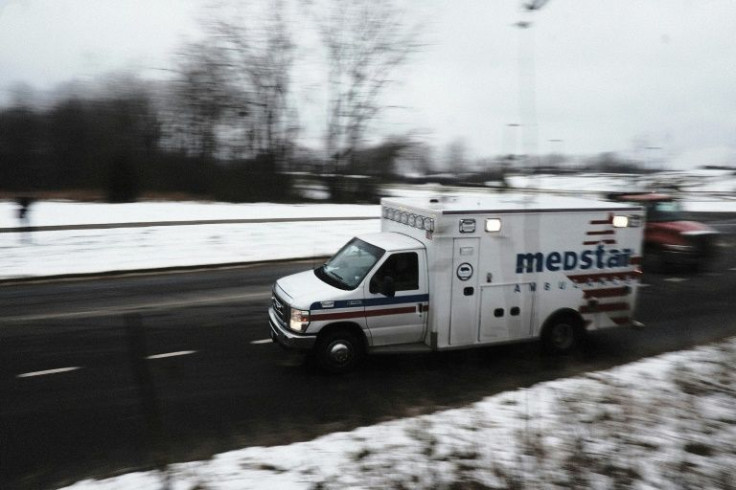 An ambulance leaving the scene near Oxford High School in Oxford, Michigan, where police say a 15 year old opened fire, killing three students and leaving eight others, including one teacher, wounded.