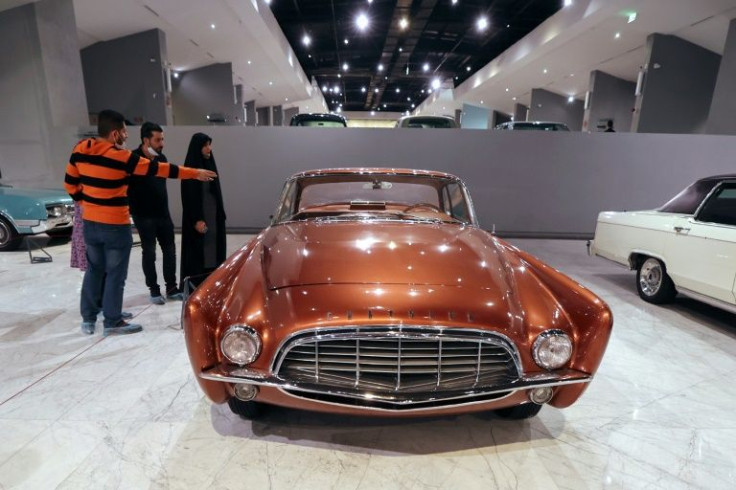 Visitors look at 1956 Chrysler 300, one of over 50 vintage cars in the museum on the outskirts of Tehran