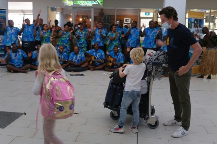 Holidaymakers are greeted by traditional cultural groups as Fiji opens its borders to international travellers for the first time since the Covid-19 pandemic swept the globe and devastated its tourism-reliant economy.