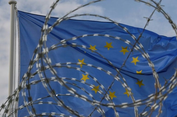 A European Union flag flutters behind the barbed wire at a new "closed" reception centre for migrants on the Greek island of Kos -- rights groups have criticised these types of camps for their restrictive measures