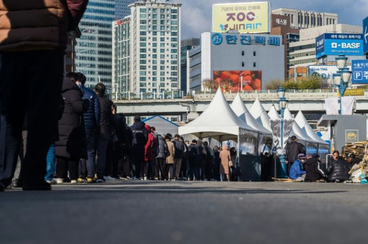 People queue for coronavirus tests in Seoul