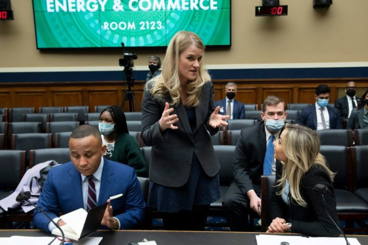 Former Facebook employee Frances Haugen (C) talks with Rashad Robinson (L), President of the Color of Change, and Kara Frederick (R), Technology Policy Research Fellow at the Heritage Foundation, before a hearing on Capitol Hill