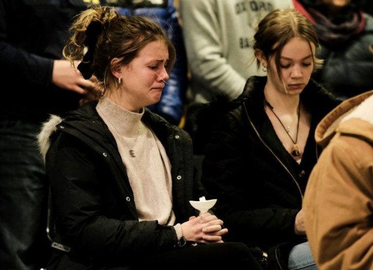 Students, parents, teachers, and community members gather for a vigil at the Lake Point Community Church following a shooting at Oxford High School in Oxford, Michigan that left four students dead.