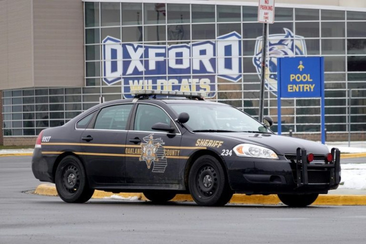 A police vehicle outside of Oxford High School in Oxford, Michigan, where four students were shot dead by a 15-year-old fellow student.
